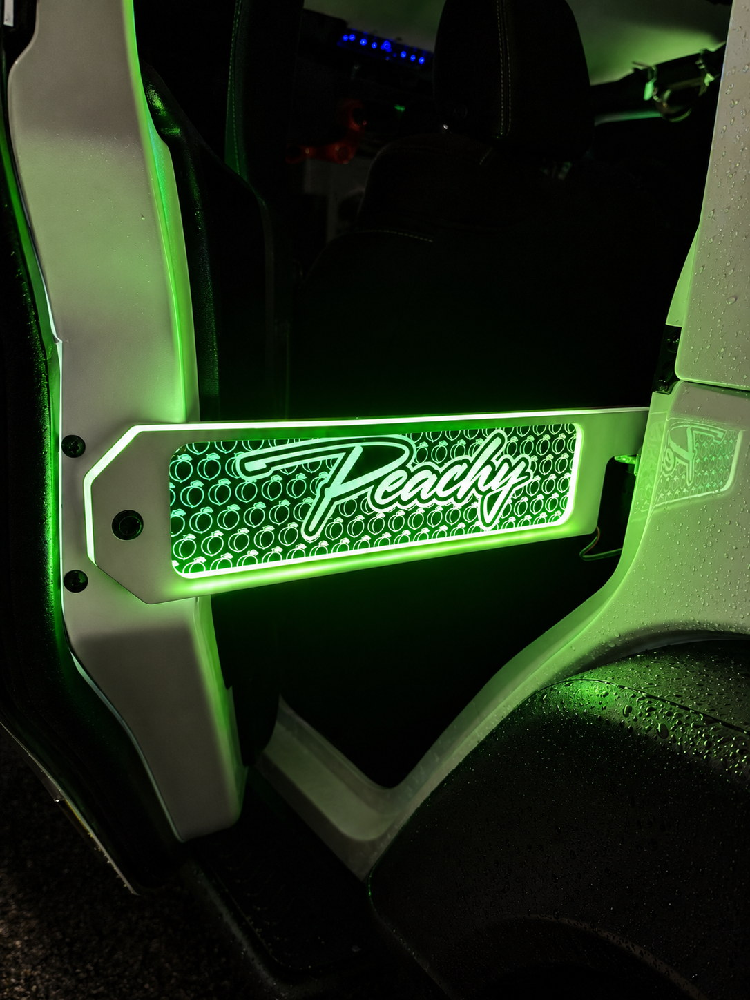 Lit FX custom engraved Peachy LED door prop glowing green on a white Jeep