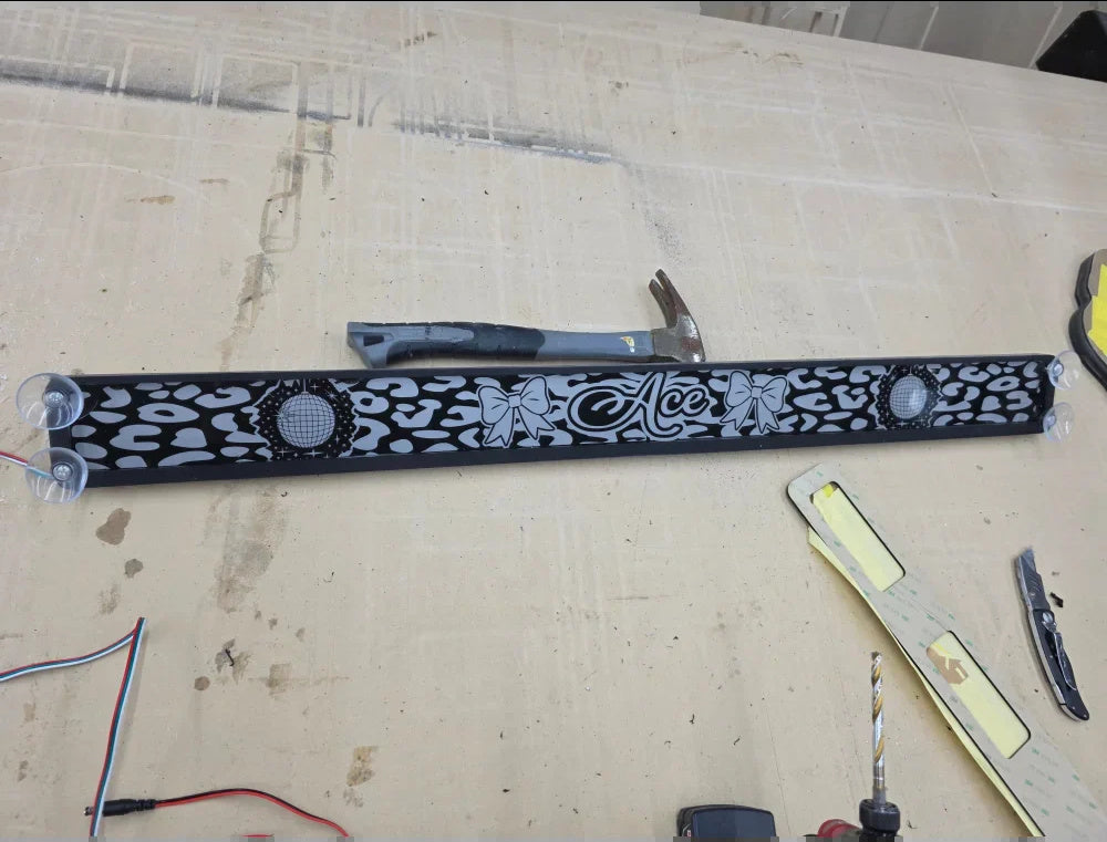 Lit FX custom engraved removable acrylic dash plaque with suction-cup mounting hardware during SMS Car Audio fabrication