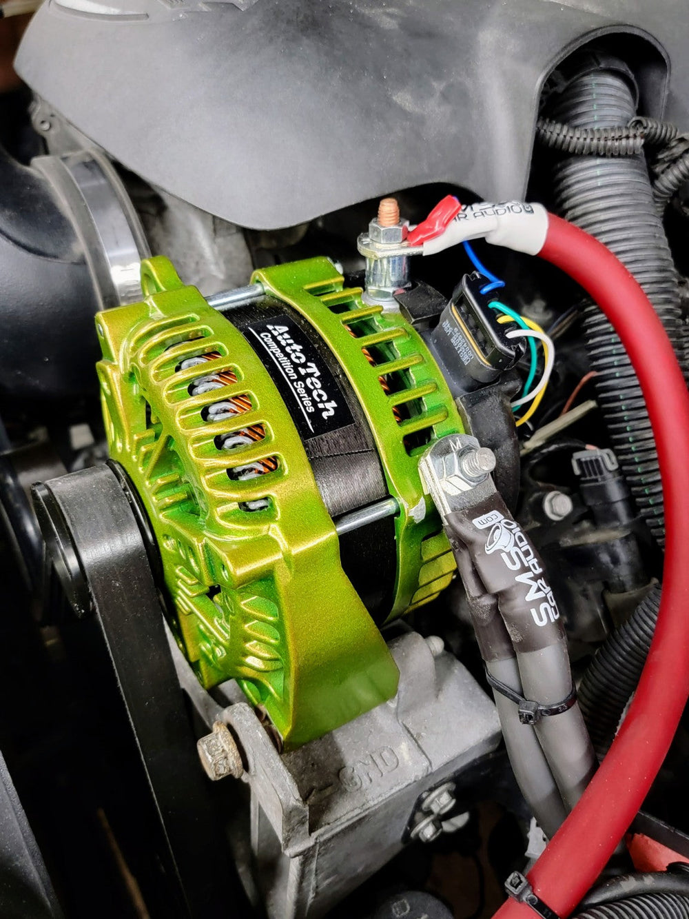 Autotech Engineering green high-output alternator installed by SMS Car Audio