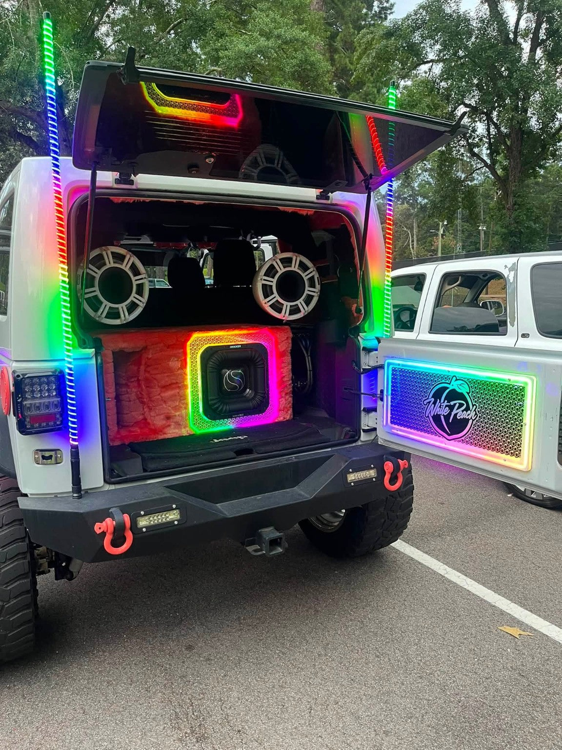 Lit FX custom engraved Jeep tailgate LED panel installed on a white Jeep with RGB lighting and custom audio system