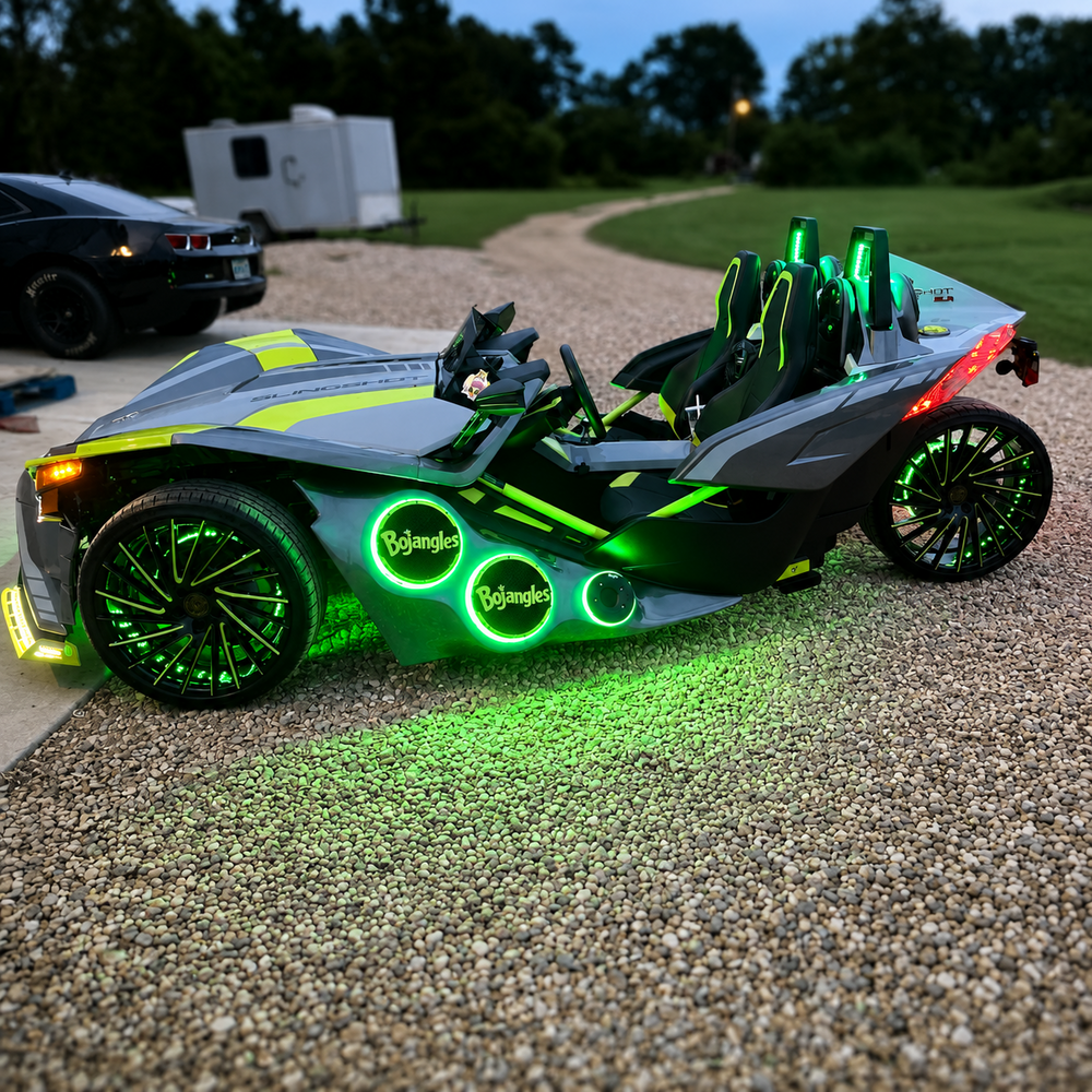 Lit FX acrylic LED speaker rings installed on a custom Slingshot with green lighting