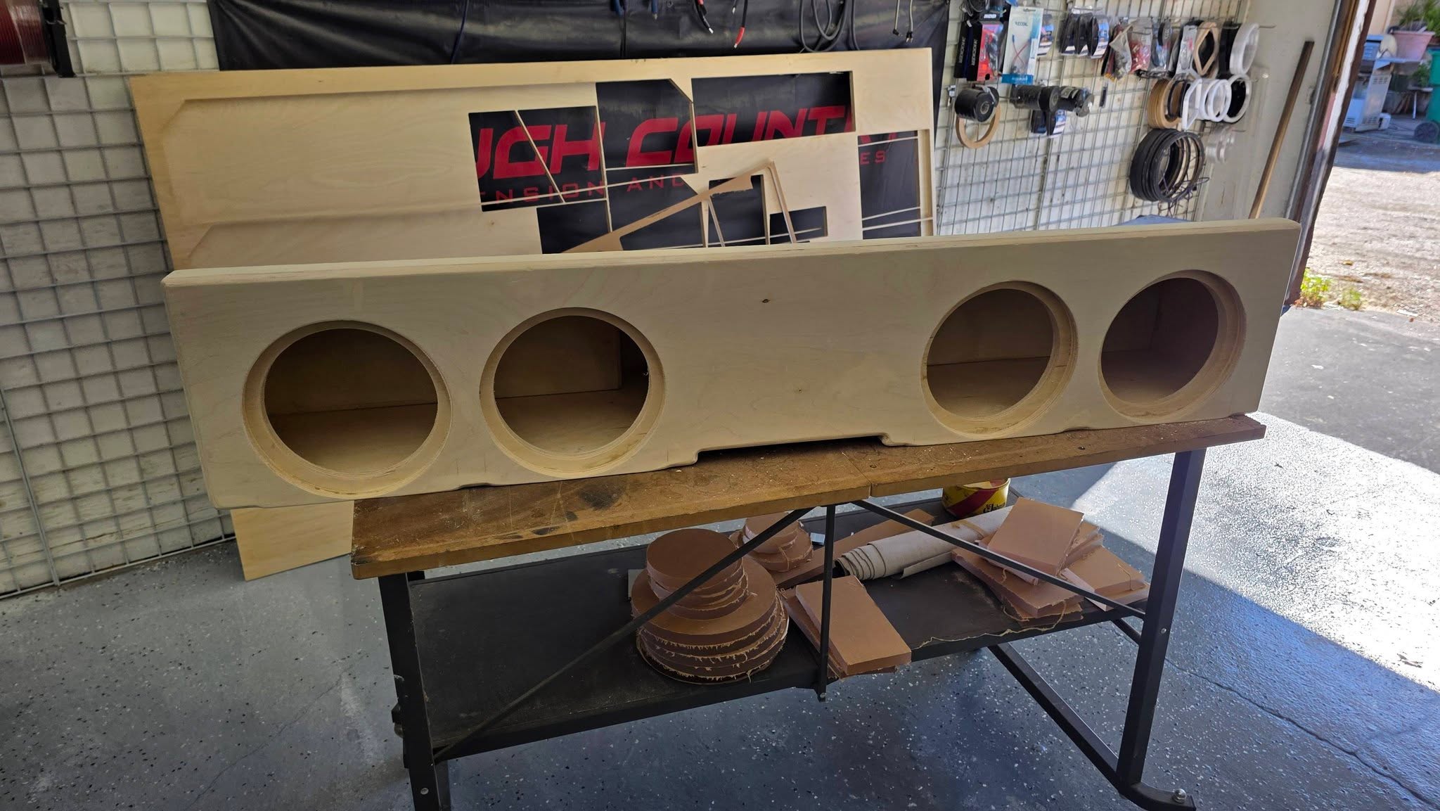 Finished bare-wood Chevrolet four 8-inch under-seat enclosure by SMS Car Audio