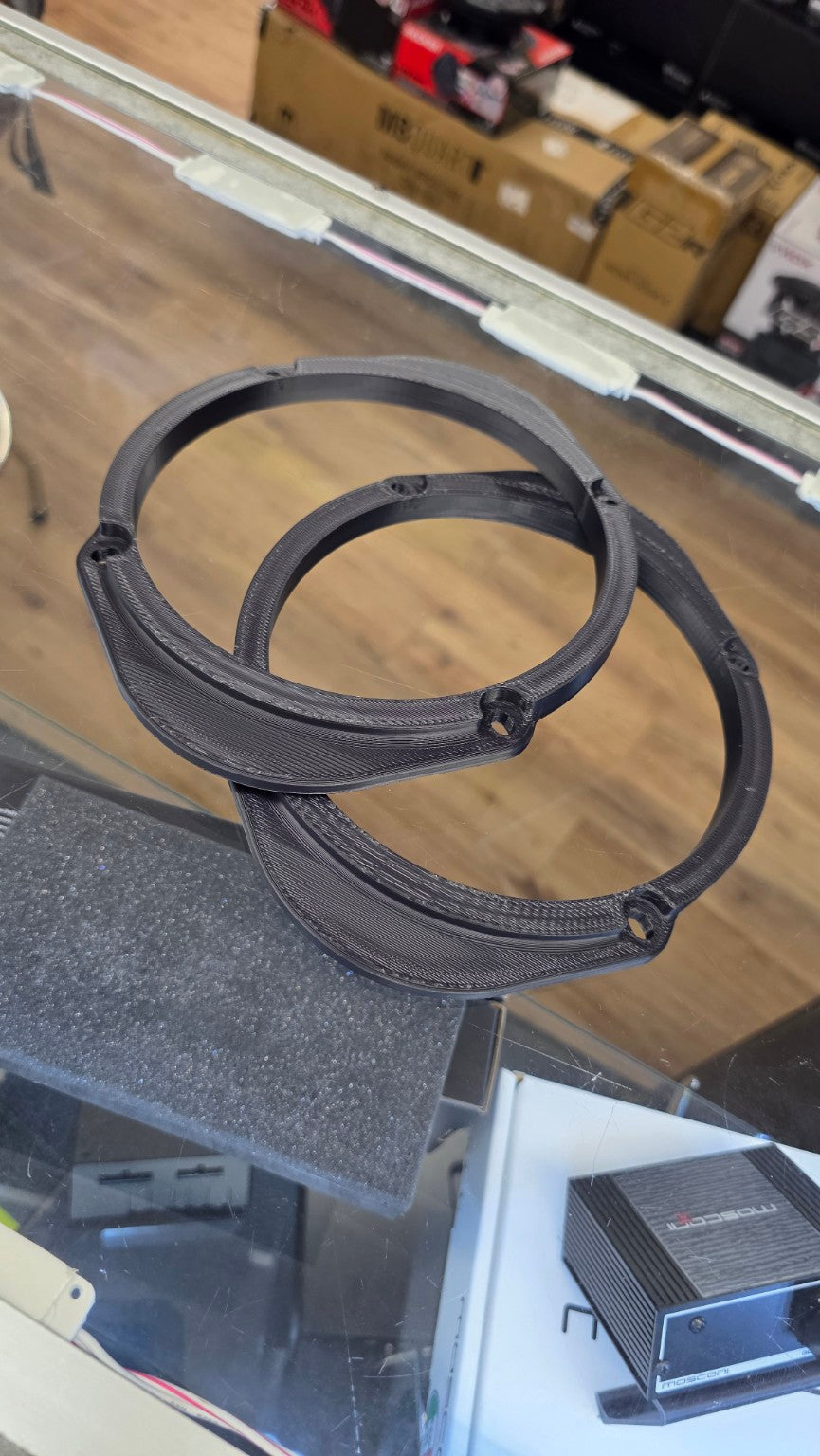 SMS Precision 6x8 and 5x7 to 6.5-inch 3D-printed speaker adapter pair on the SMS Car Audio counter