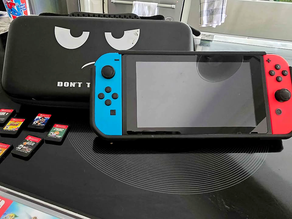 Actual used Nintendo Switch V2 console with Neon Blue and Neon Red Joy-Con controllers