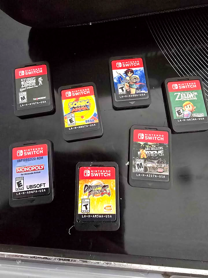 Actual seven loose Nintendo Switch game cartridges included with the used Nintendo Switch V2 bundle